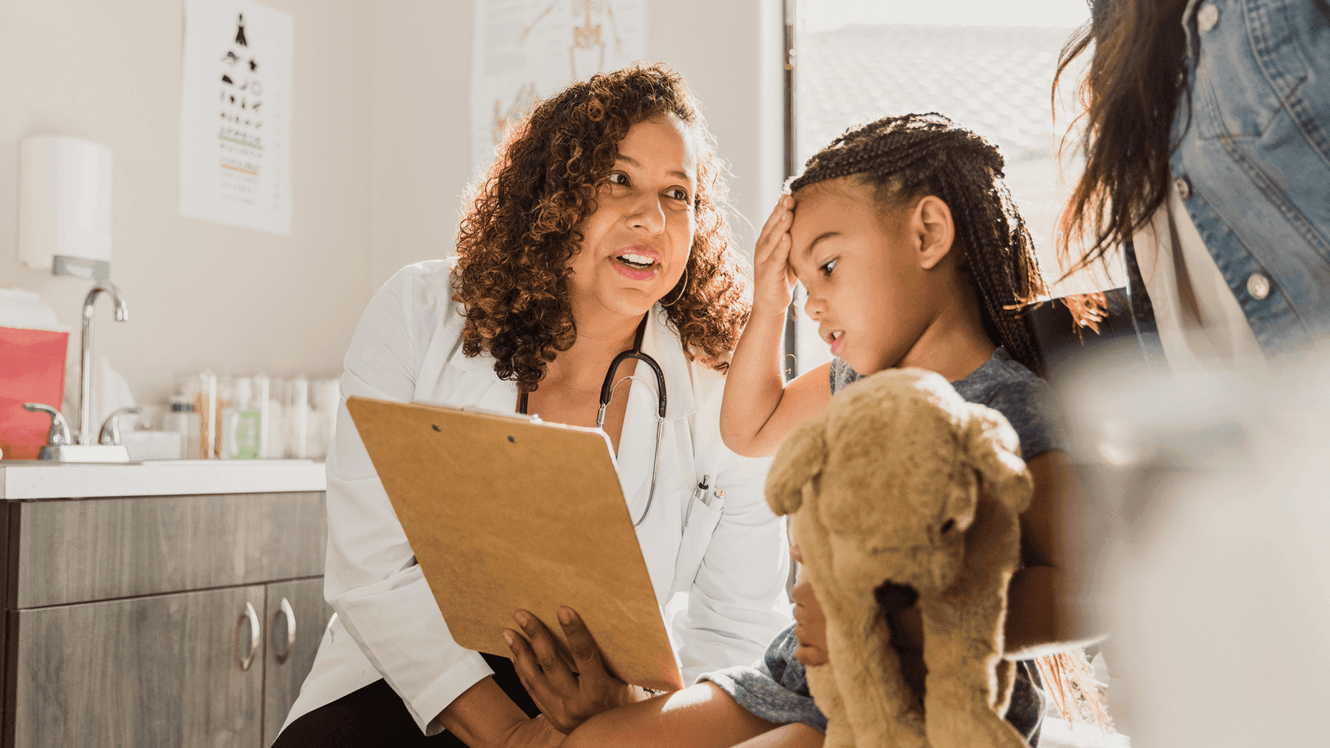 Young girl with headache meets with doctor